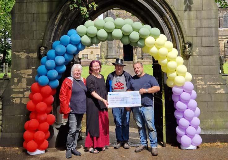 Rev. Anna, Commitee Chair and Secretary, accept a check totaling £5000 from Kurt Hill of North West Fun Fairs, 
as the start of the Boddan lodge Fund